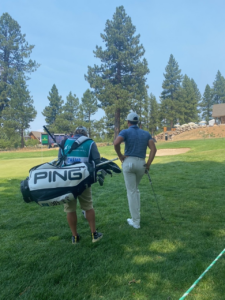 Cameron Champ and his caddy looking at green