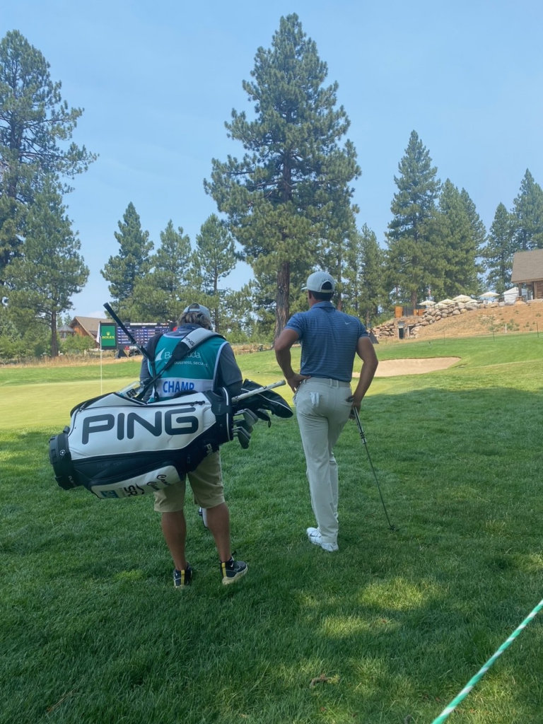 Cameron Champ and his caddy looking at green