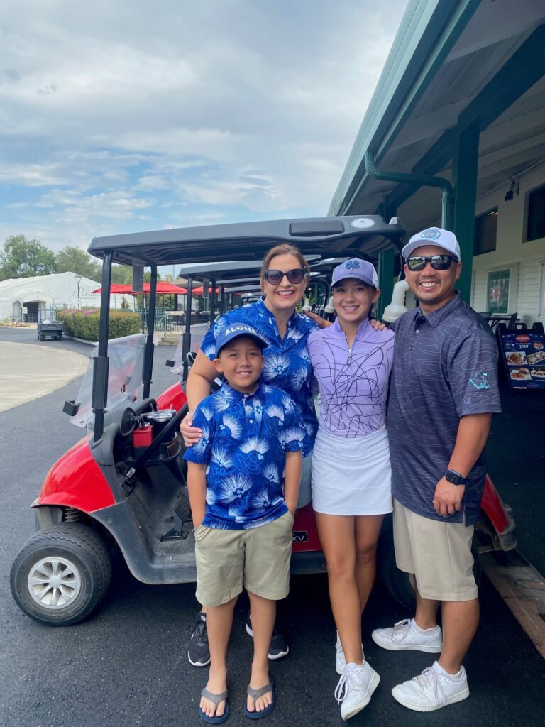 Sienna Lyford poses with her family in front of a golf cart outside the Haggin Oaks Pro Shop.