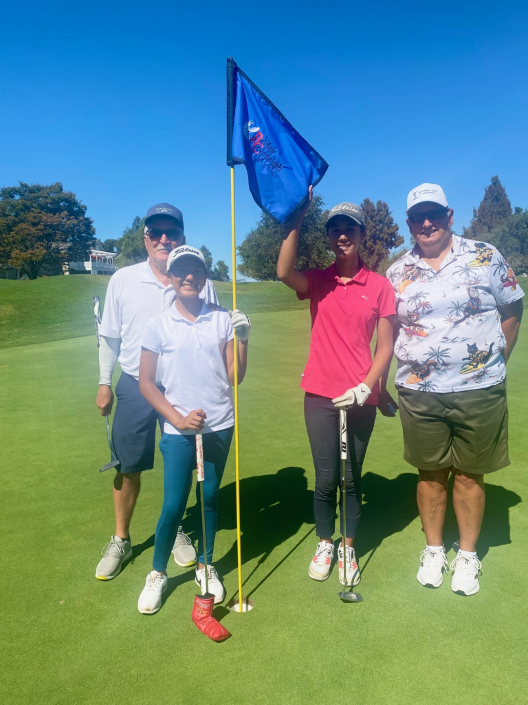 Sophia & Olivia Lee along side Sacramento City Golf Council members Nanci Smith and Mark Perry on green at Bartley Cavanaugh Golf Course