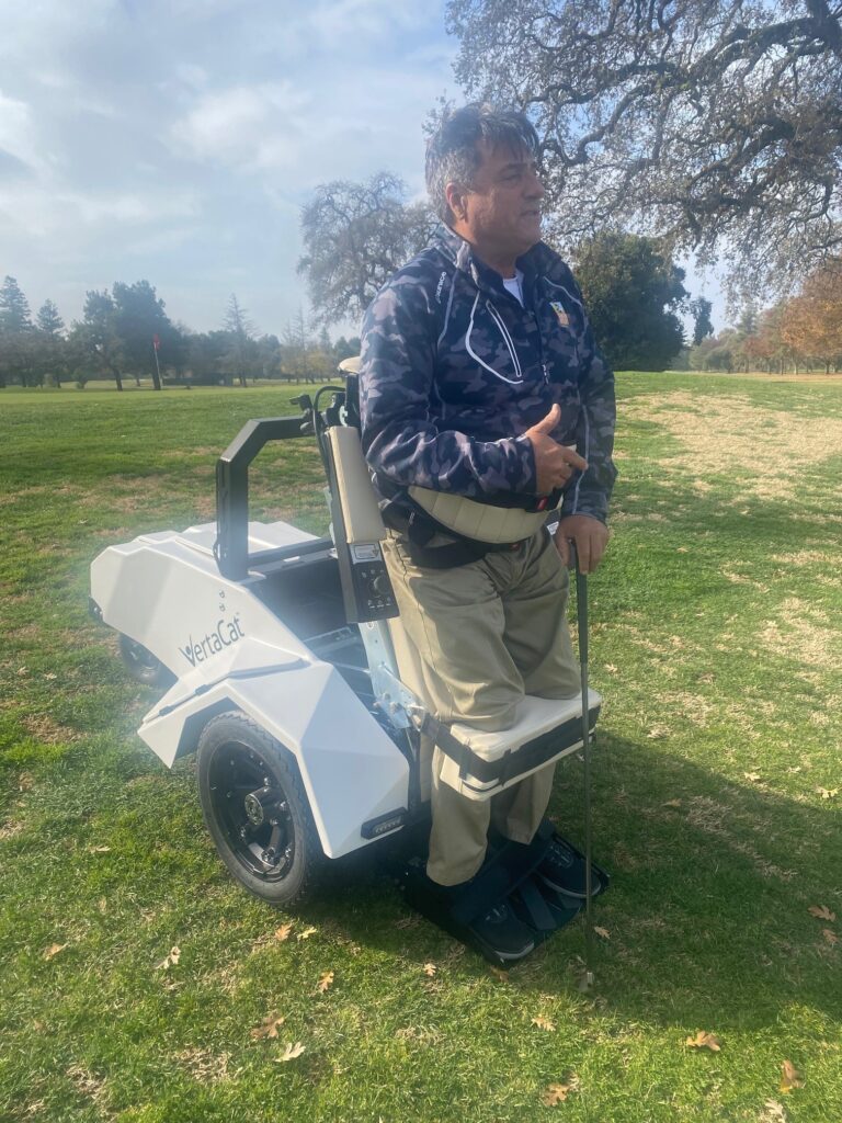 Golfer standing in adaptive cart