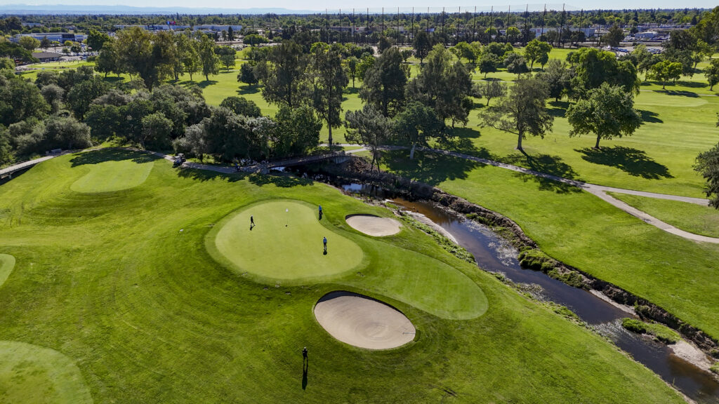 Aerial drone view with two AJGA golfers on the green